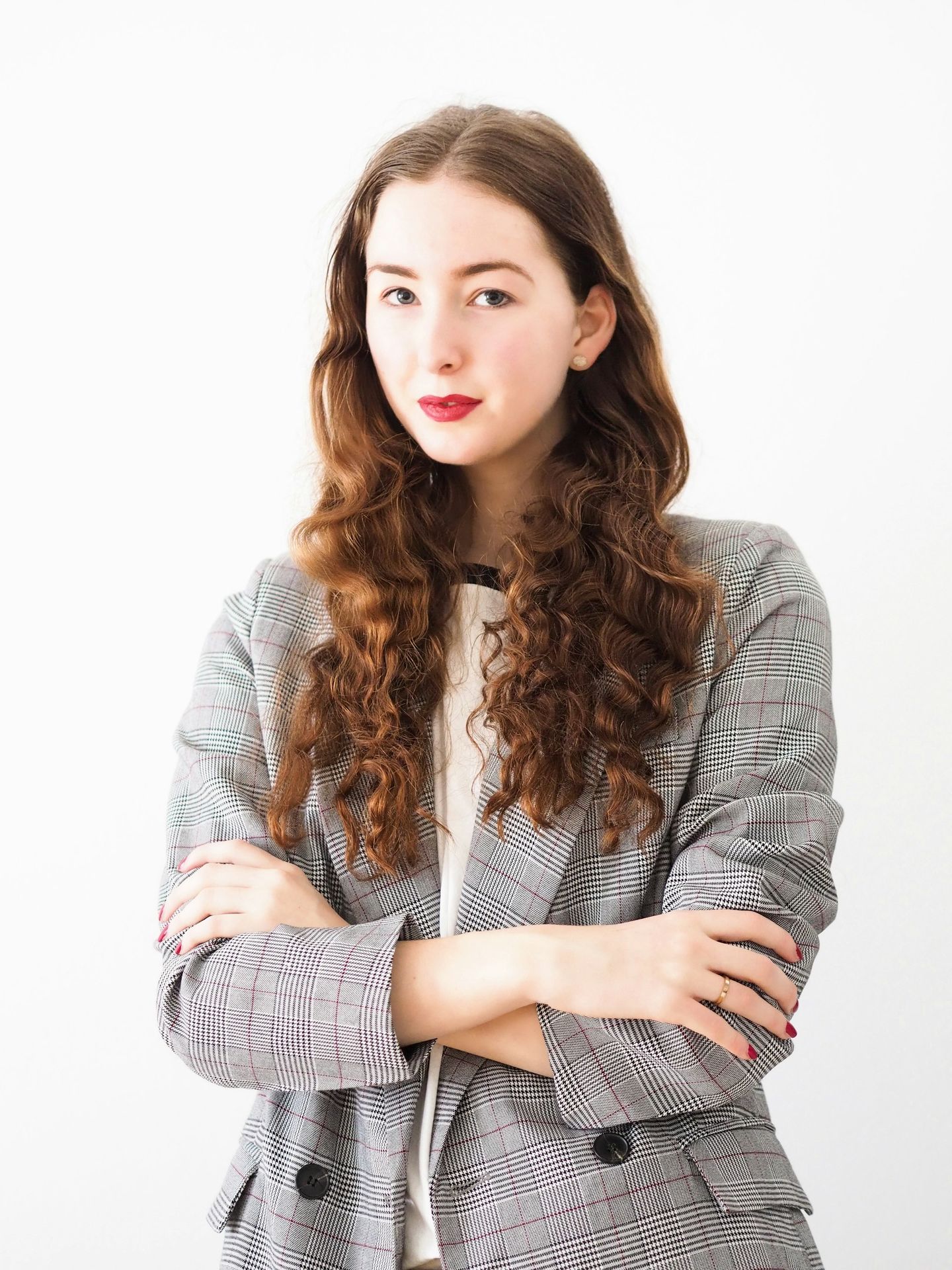 woman in gray cardigan and black and white striped dress